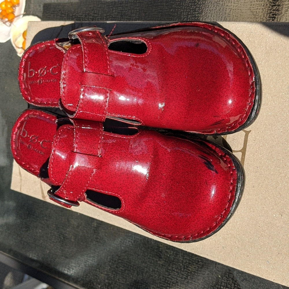 Red patent leather clogs